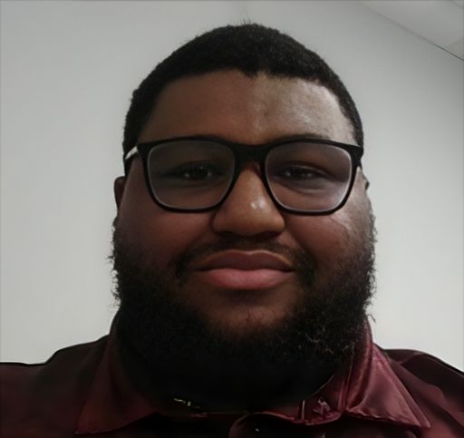 A headshot image of Dominic Williams
