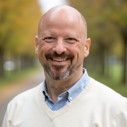 A headshot image of Andrew Breton