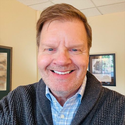 A headshot image of Kirk Henderson