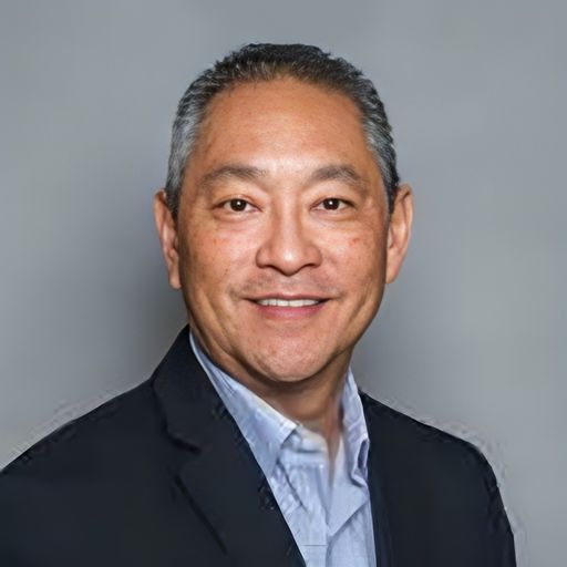 A headshot image of Tom Tamura
