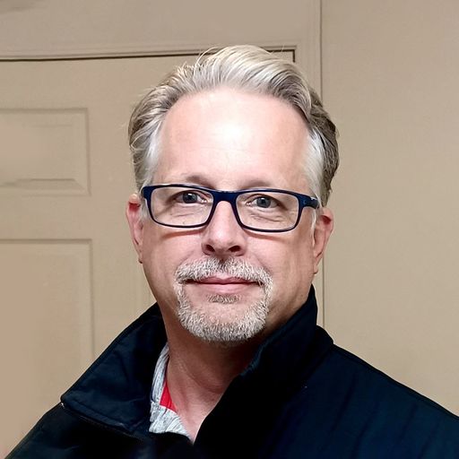 A headshot image of Kirk Stoner